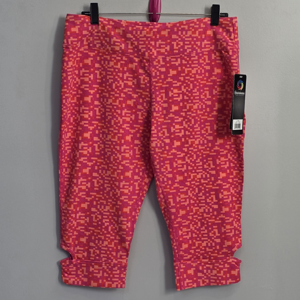 Rainbeau Curves activewear leggings featuring a pink & orange pixelated pattern